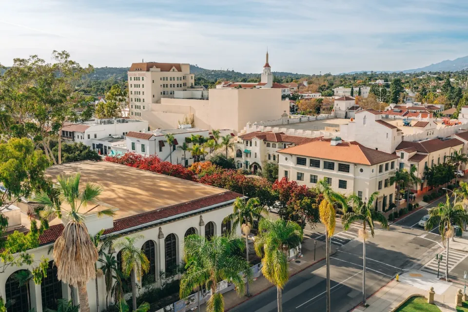Aerial view of Spanish revival style buildings with red tile roofs in downtown Santa Barbara, California.